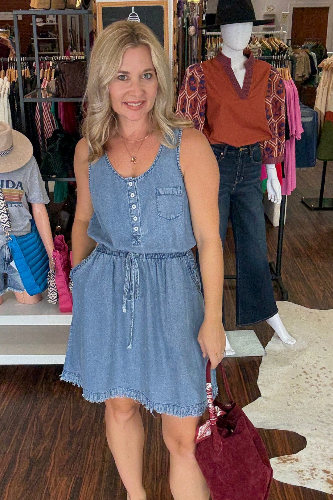 This Denim Henley Dress features a scoop neck and adjustable drawstring waist