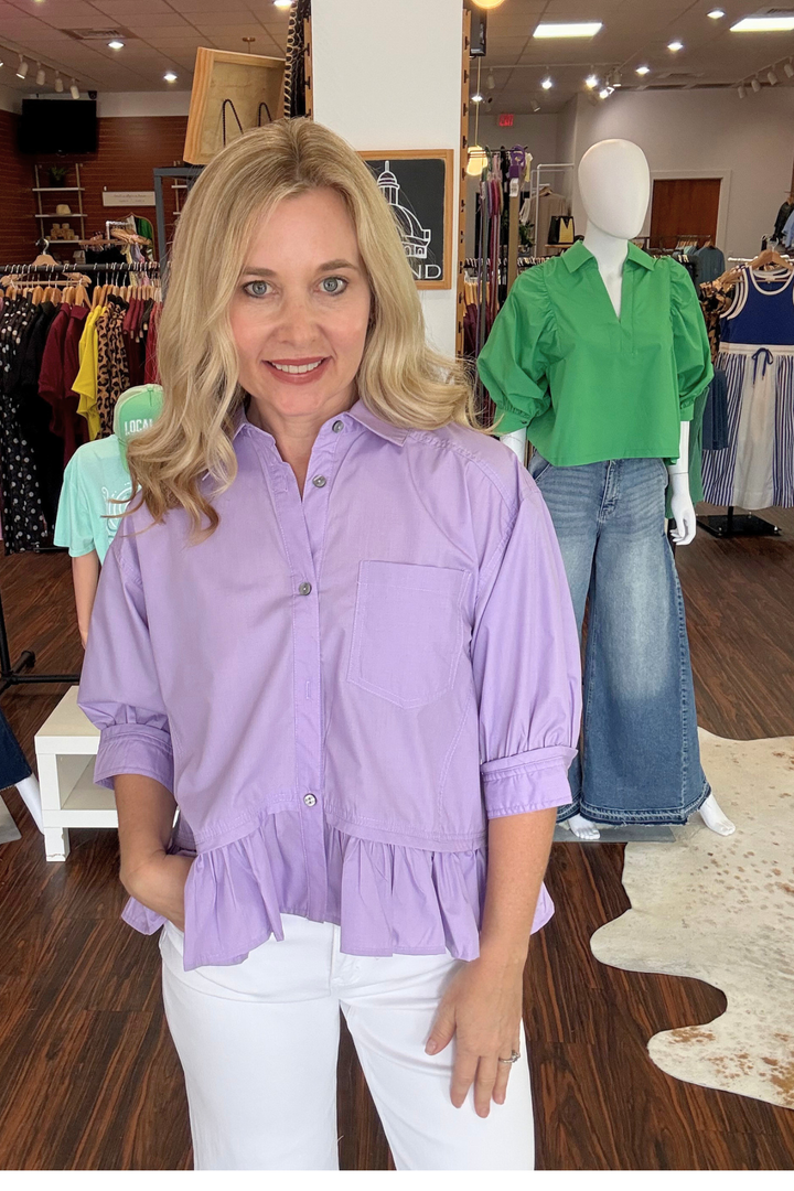 Effortless style meets everyday comfort in this solid, 3/4 sleeve button-down top. The charming ruffle hem adds a playful touch, while the front button closure and chest pocket deliver practical functionality. Finished with buttoned cuffs and crafted from lightweight woven fabric, this unlined piece is perfect for layering or wearing solo. Non-sheer and versatile, it's a wardrobe essential that transitions seamlessly from casual to polished.