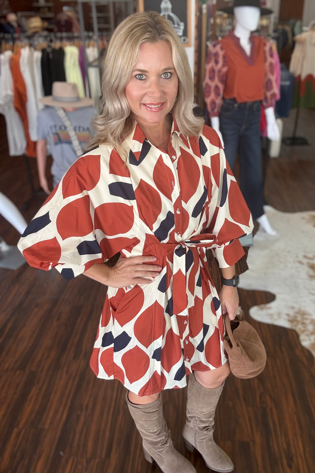 This lightweight 3/4 sleeve mini dress blends vibrant orange and navy prints with modern details like a self-tie waist and shirt collar. Designed with button-front closure and convenient side pockets, it offers both style and function. 