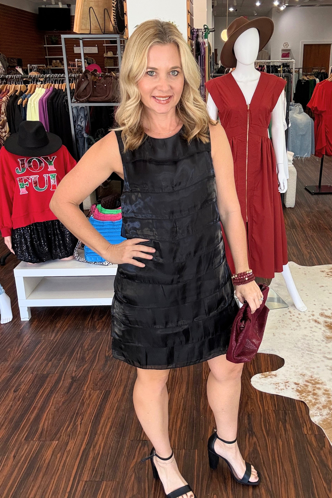 Upgrade your wardrobe with our modern Black Ruffled Detail Sleeveless Mini Dress. This versatile piece features a sleeveless design, with a front ruffle detail that adds a touch of elegance. The mini dress length and button closure at the neck make it perfect for any occasion.