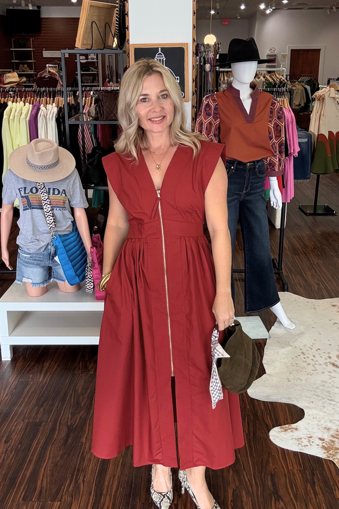 Midi dress features a modern V-neck with a zip-front closure and cap sleeves for a sleek look. Textured stitching bands add subtle detail, while a smocked waistband at the back 