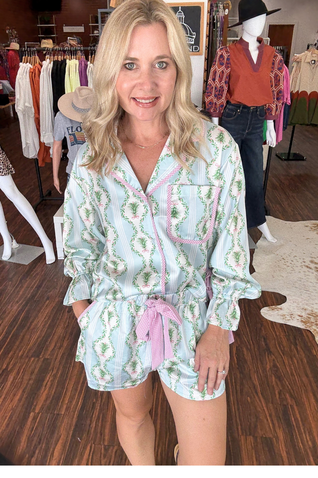 Embrace cozy holiday vibes with this Christmas Print Satin Gingham Pajama Set. Featuring a light blue background adorned with festive Christmas tree prints, complemented by chic pink gingham trim