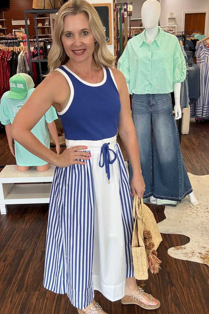 

Effortless style meets everyday comfort in this striped color block midi dress. The sleeveless silhouette pairs perfectly with layering pieces, while the drawstring waist tie lets you customize your fit. Practical side pockets keep essentials within reach. Crafted from lightweight woven fabric with a full lining for coverage and breathability, this versatile dress transitions seamlessly from casual outings to relaxed gatherings. Model is wearing size small. Dress runs TTS.&nbsp;