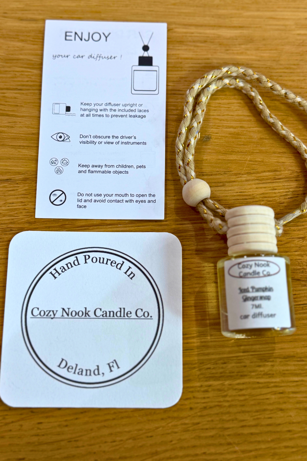 Cozy Nook Candle Co. Car Diffuser, crafted by hand in DeLand, FL. This sleek diffuser brings a fresh, inviting scent to your vehicle, combining style and function for a modern driving experience. Its artisanal quality ensures unique charm while keeping your space refreshingly fragrant on every drive.