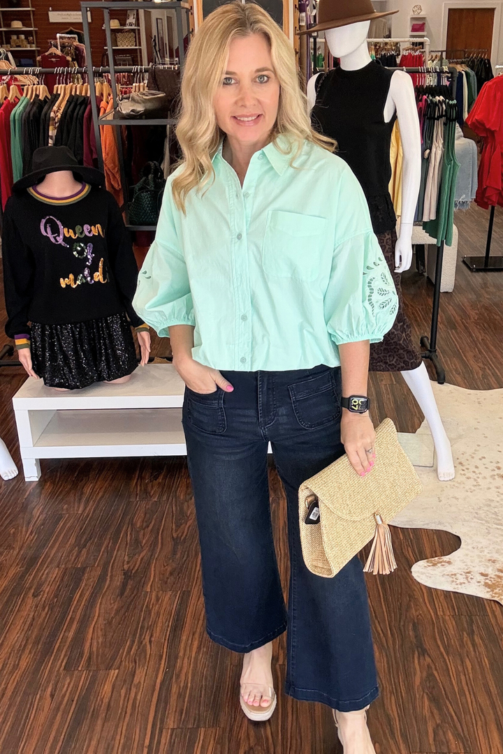 
This cut-out embroidered bubble sleeve top combines playful details with effortless style. The collared button-down front pairs with dramatic drop-shoulder bubble sleeves featuring delicate embroidery and strategic cut-outs for visual interest. Elastic cuffs keep the voluminous sleeves in place, while the bubble hem adds dimension to the relaxed silhouette. Perfect for layering or wearing solo, this piece brings contemporary edge to your everyday wardrobe.