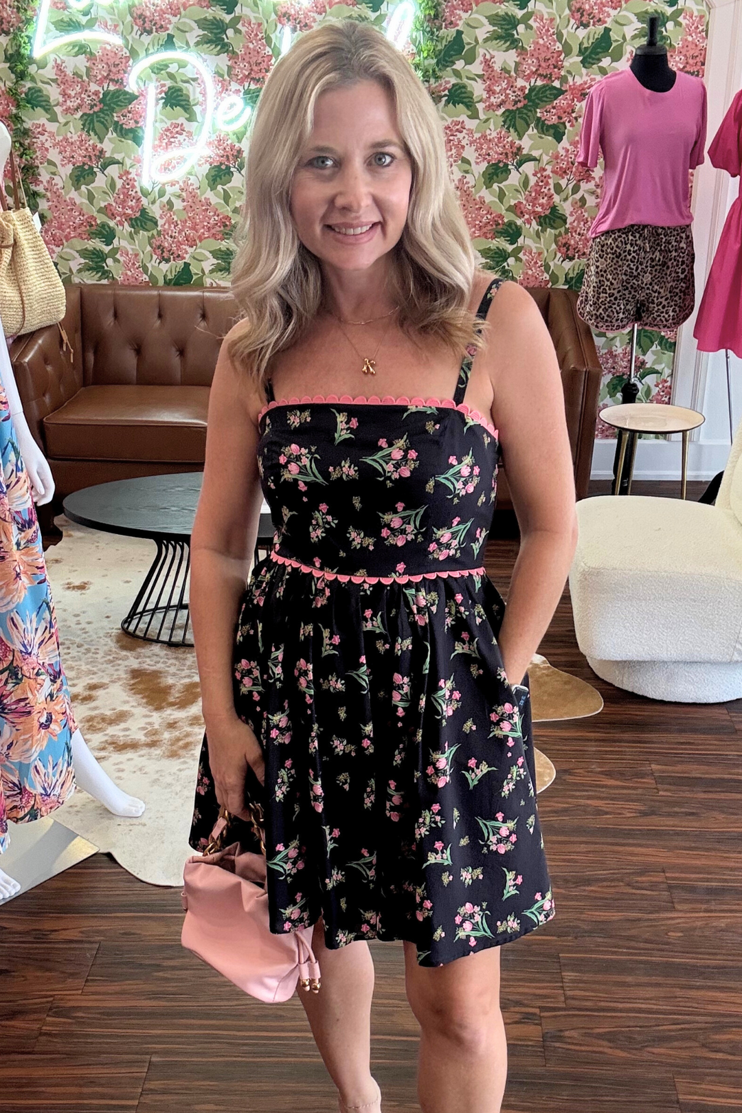  floral mini dress features scalloped pink trim and convenient pockets for your essentials. The back smocking ensures a comfortable fit
