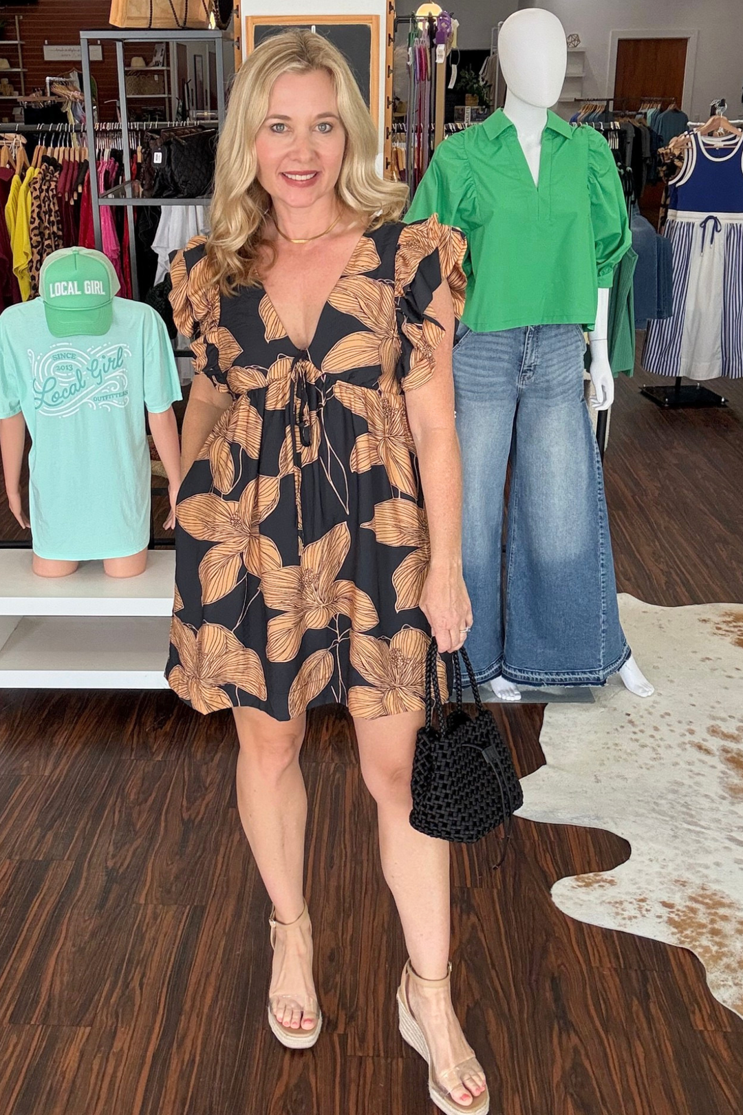 Embrace effortless elegance in this charming floral print mini dress. Delicate ruffled cap sleeves frame a plunging V-neckline adorned with a tie detail, while the empire waist creates a flattering, feminine silhouette. The relaxed babydoll cut offers comfortable movement, and practical side pockets add everyday functionality. A hidden back zipper ensures a seamless finish. Perfect for casual outings, garden parties, or weekend adventures.