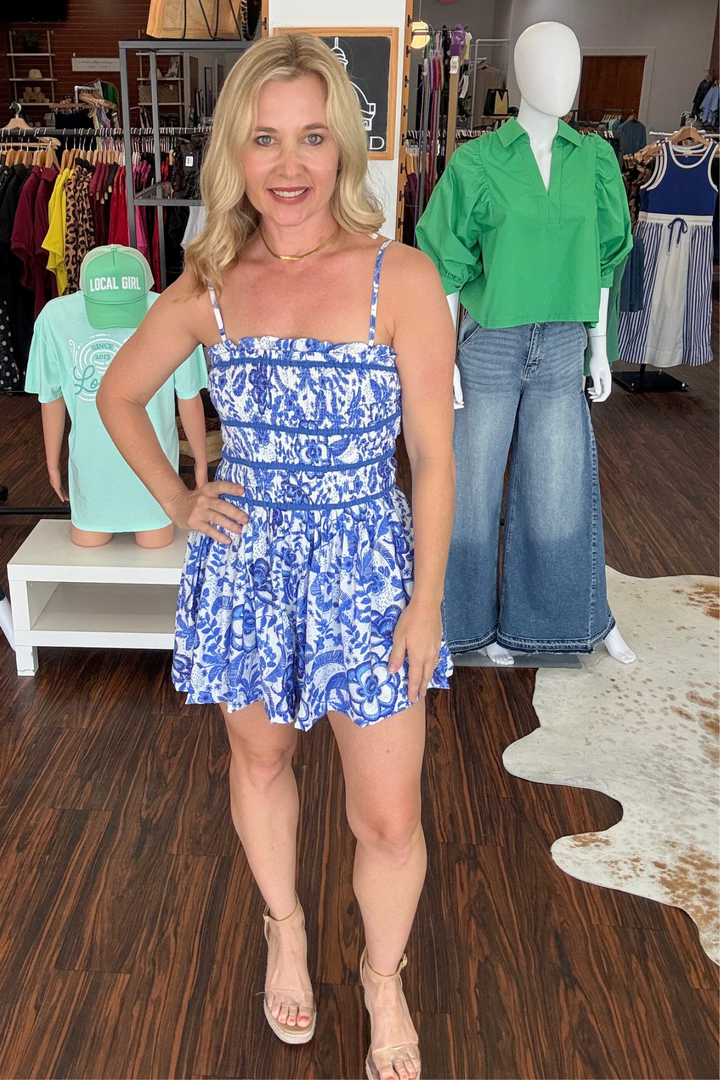 
Effortless style meets playful comfort in this floral print romper. The smocked bodice creates a flattering, adjustable fit while removable straps let you customize your look—wear it strapless for summer days or with straps for added support. Delicate ruffle trim and pleating details add dimension and movement to every wear. Perfect for warm-weather outings, casual gatherings