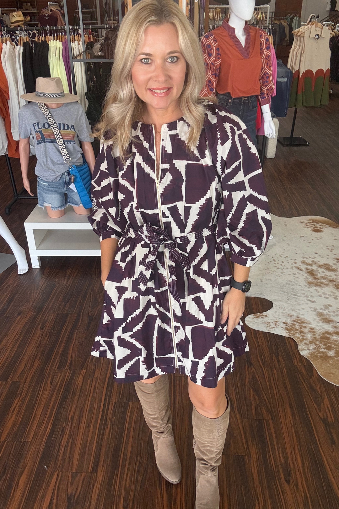 This geometric print mini dress combines modern style with comfort. Featuring 3/4 sleeves and a front zipper closure, it offers easy wear and a sleek silhouette. The self-tie waist belt allows for a customizable fit, while the lightweight woven fabric ensures breathability. 