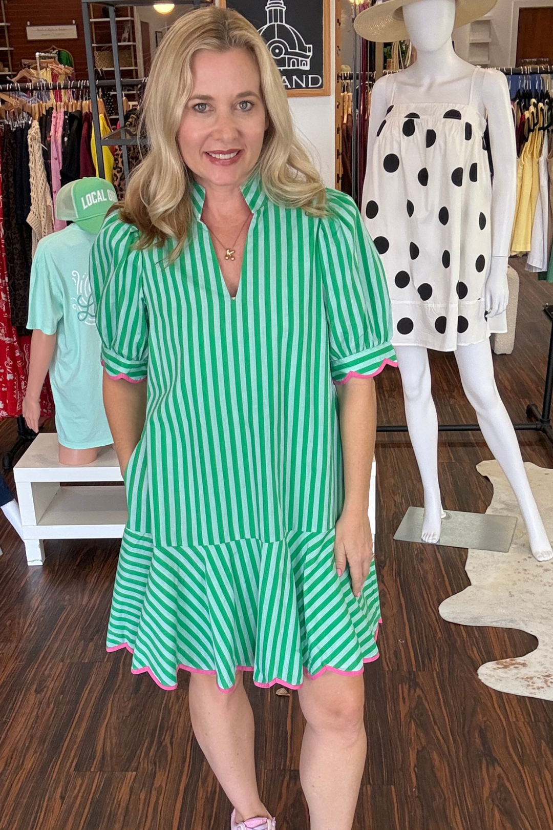 Effortless elegance meets everyday comfort in this solid puff short sleeve mini dress. The notch collar V-neck creates a flattering silhouette, while delicate scallop accent trim adorns the sleeves and hem for a refined touch. Practical side pockets keep essentials within reach. Crafted from lightweight woven fabric that's fully lined for a non-sheer finish, this dress moves with you throughout the day. Perfect for casual outings or dressed up for a night out. Model is wearing size