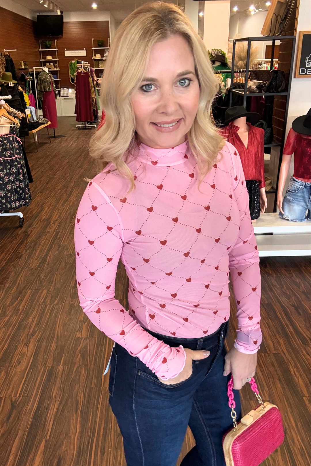 
Elevate your everyday wardrobe with this contemporary mesh top, featuring a chic mock neck and eye-catching argyle-inspired heart pattern. The sheer mesh construction creates an effortlessly layered look, while delicate lettuce hem detailing adds a refined finish. Perfect for styling over basics or pairing with your favorite camisole, this piece brings modern sophistication to any outfit.&nbsp;