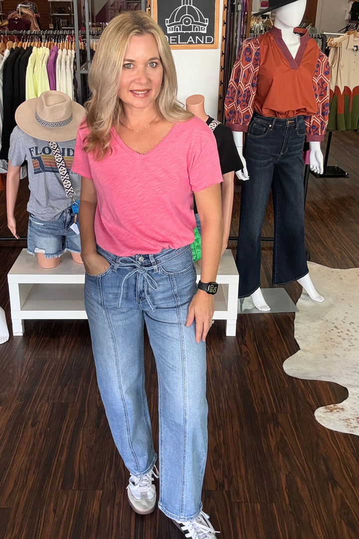 High Rise Barrel Jeans with Tie Waist combine comfort and style with their stretch denim fabric and flattering high waist design. The adjustable tie waist enhances fit, while seam detailing and a finished hem add a tailored touch. Cropped at the ankle in a light medium wash, these wide barrel jeans offer a modern silhouette perfect for effortless everyday wear.