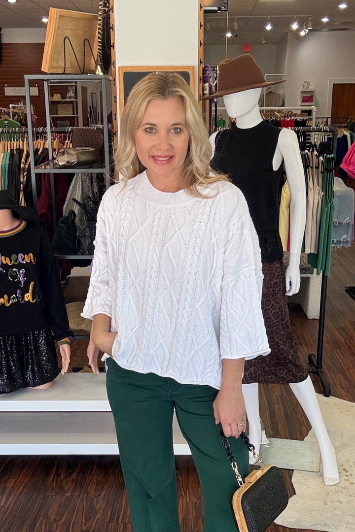  The three-quarter sleeves and braided detail add visual interest, while the unlined construction keeps things breathable and comfortable. Perfect for transitional seasons or layering year-round, this solid sweater delivers understated sophistication without the bulk. 