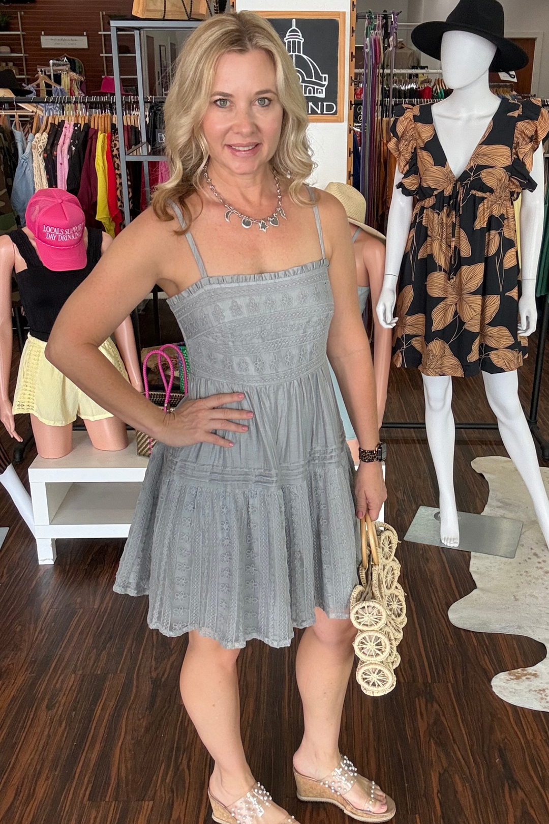Delicate lace detailing frames the neckline and skirt hem, adding romantic flair to this tiered mini dress. Smocking across the back provides gentle shaping and visual interest, while adjustable straps ensure a customized fit for all body types. The layered silhouette creates movement and dimension, perfect for casual outings or dressed-up occasions. Lightweight and feminine, this piece transitions effortlessly from day to night.