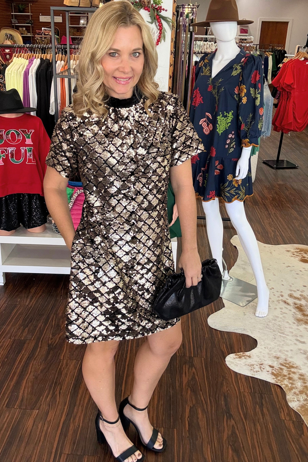 Elevate your evening look with the Leslie Sequin Nova Back Bow Tie Mini Dress. This show-stopping piece features shimmering silver sequins that catch the light with every move, paired with a sophisticated black velvet neckline. The standout back bow tie detail adds an unexpected touch of elegance, while the lined interior ensures comfort and confidence. This dress also features pockets! Perfect for cocktail parties, date nights, or any occasion calling for glamorous style. 