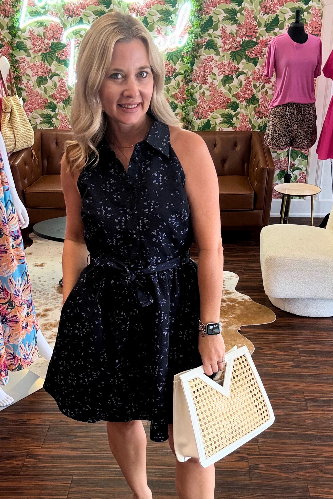 features a dreamy midnight floral pattern and a flattering tie-waist that hugs in all the right places. The practical half-button front adds a flirty peek-a-boo effect, while hidden pockets (yes, pockets!) let you stash your lip gloss or phone. 