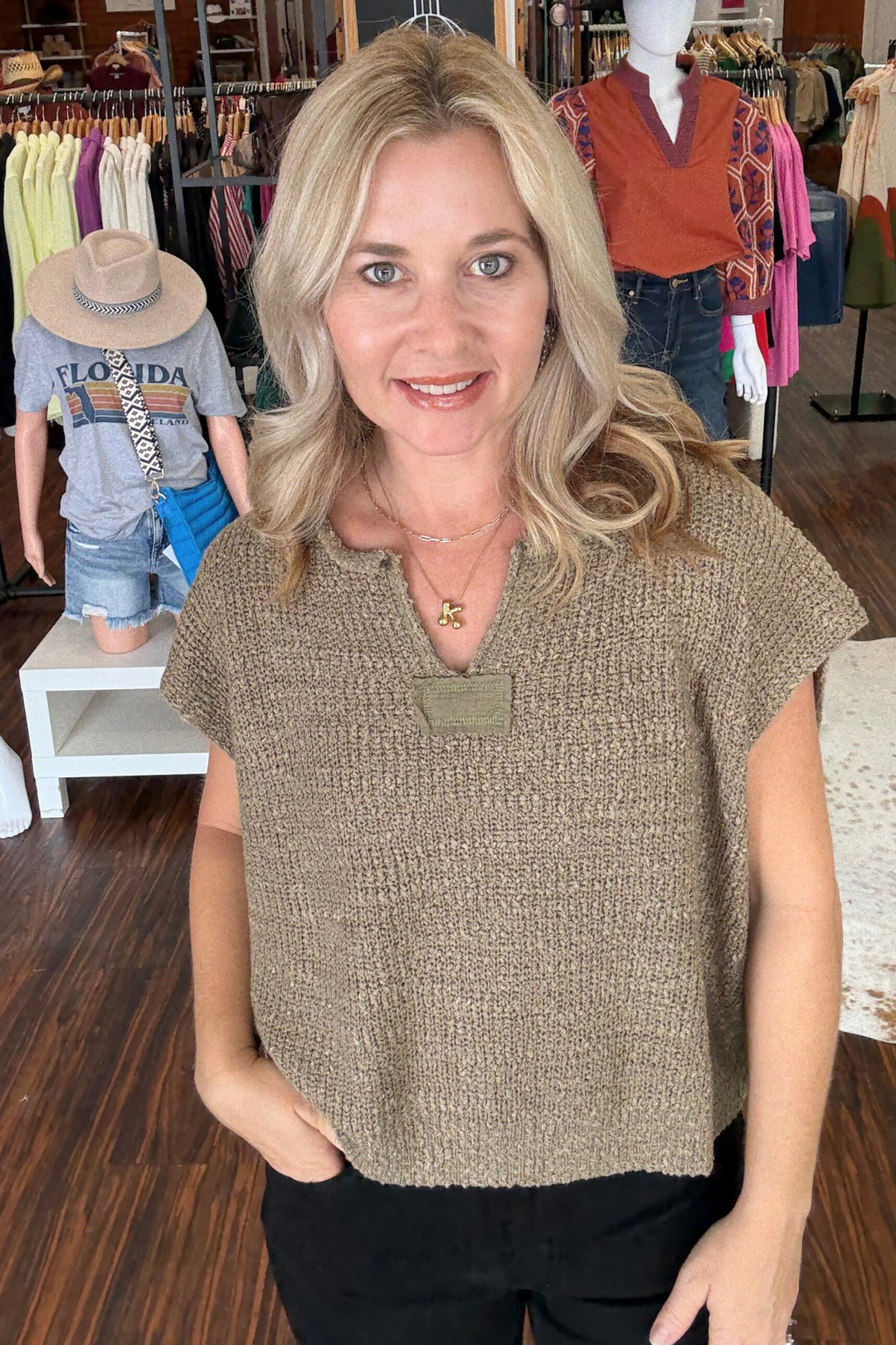 Short sleeve sweater features a sleek solid cap sleeve design and a stylish notched neckline. Crafted from soft knit fabric