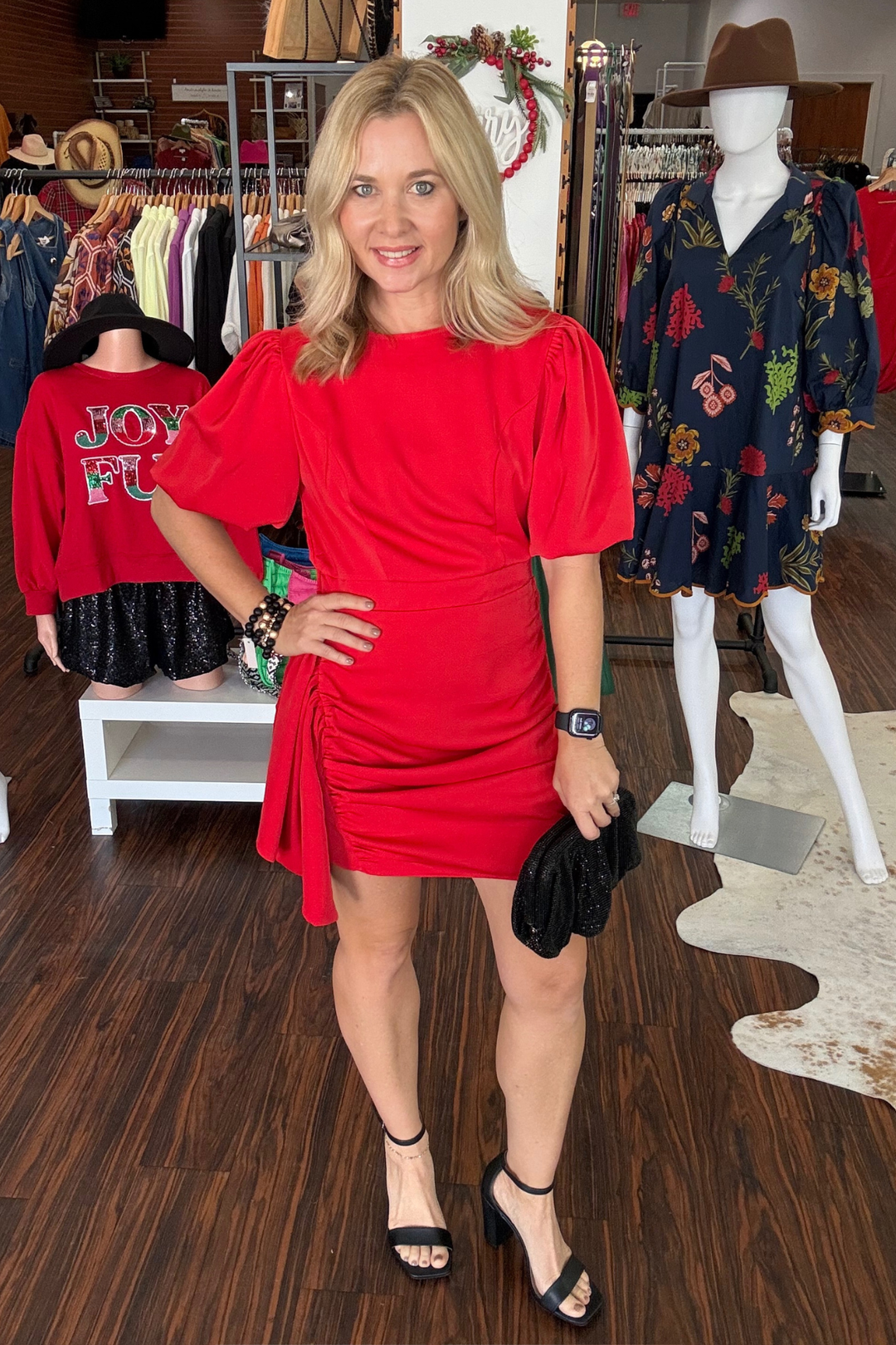 Turn heads in this striking red dress designed with contemporary flair. Flattering side rouching creates a sculpted silhouette while dramatic puff bubble sleeves add playful dimension. The convenient back zipper ensures an effortless fit. 
