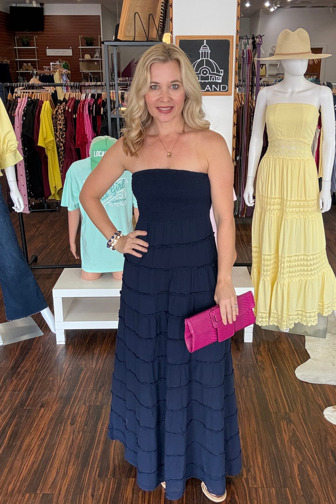 
Romantic strapless maxi that brings effortless elegance to warm-weather occasions. The fitted bodice flows into a tiered, layered skirt crafted from lightweight, airy fabric that drapes beautifully with every movement. Delicate smocking details across the back and a subtle cutout add visual interest and dimension. Perfect for garden parties, beachside dinners, and summer celebrations, the Rosalina Dress is your go-to piece for understated sophisticated