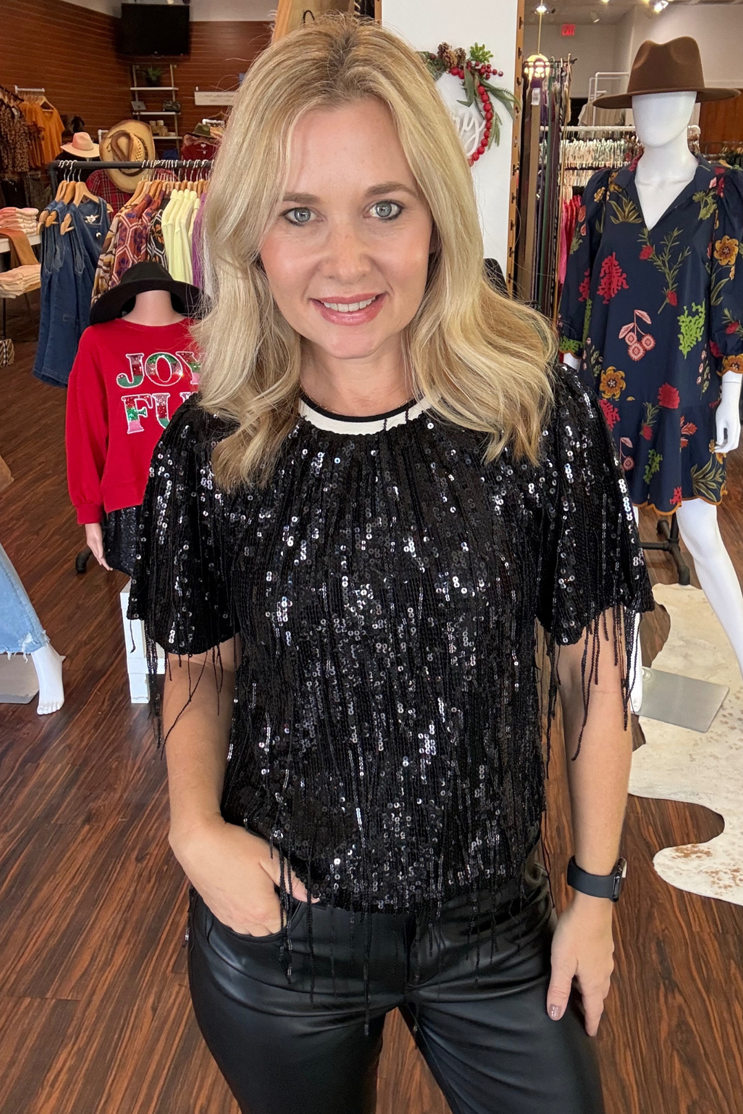 Elevate your look with this eye-catching sequin top featuring dynamic dangling fringe that moves with you. 