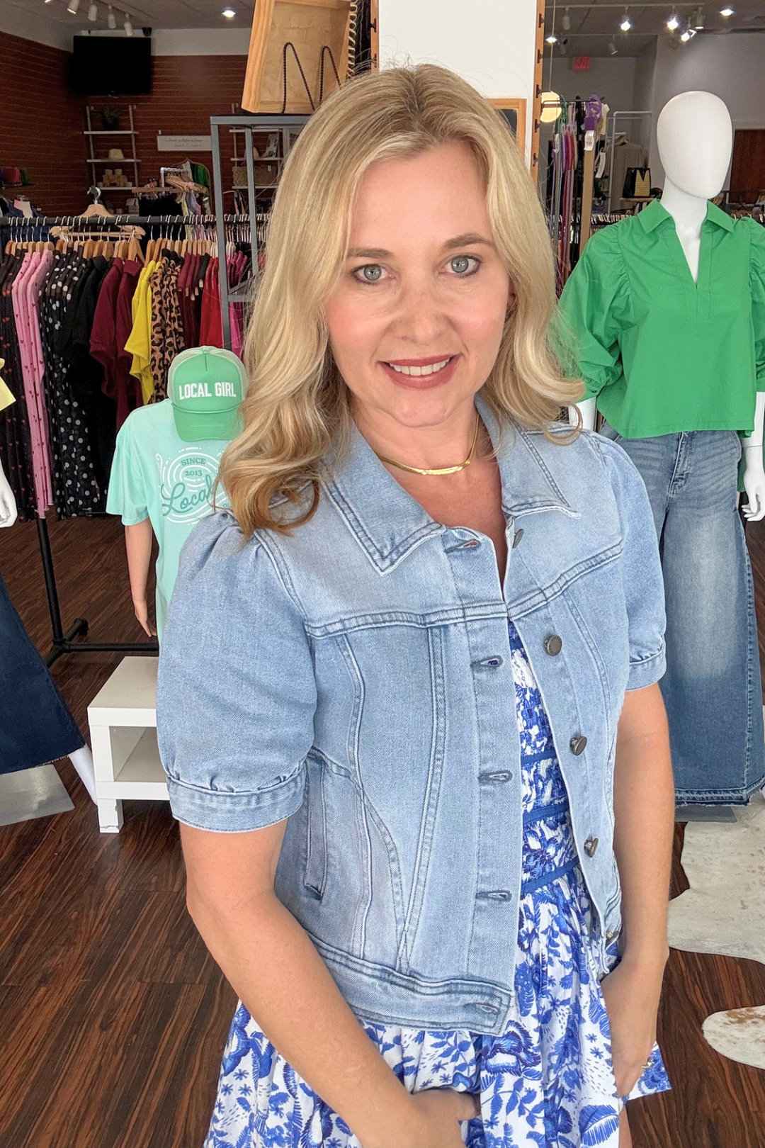 Effortless style meets practical design with this short-sleeve denim top. Crafted from classic denim, it features charming puff sleeves that add a contemporary touch and functional utility-style pockets perfect for everyday essentials. The button-down front makes layering easy, while the relaxed fit works beautifully on its own or paired with your favorite basics. A versatile wardrobe staple that transitions seamlessly from casual outings to weekend adventures. Model is wearing si