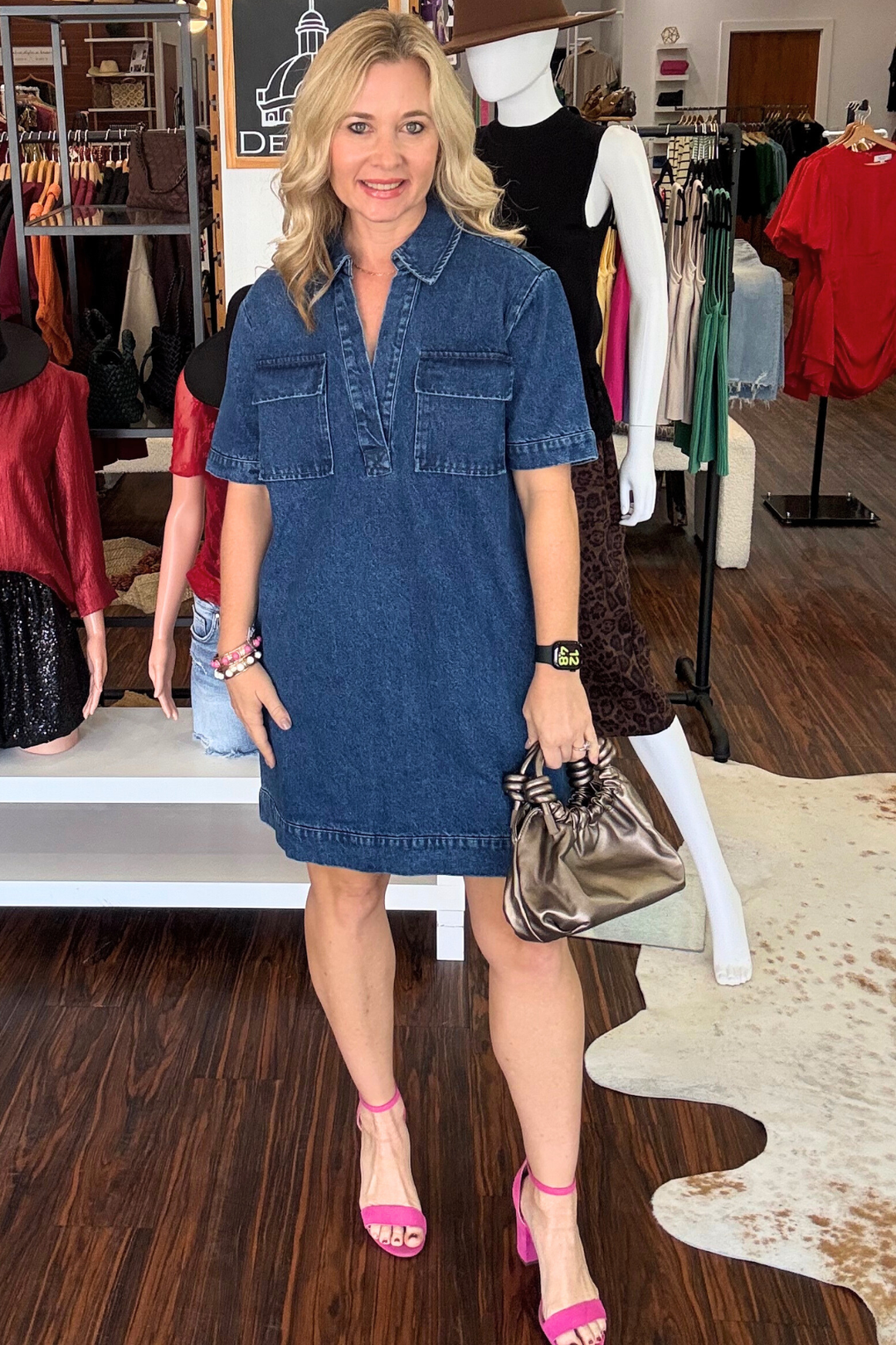 Effortless style meets everyday comfort in this washed denim mini dress. Cut with a flattering V-neckline and classic collar, it's designed for versatility. Functional front pockets add practicality, while short sleeves keep things breezy and casual. Perfect for layering or wearing solo, this wardrobe staple transitions seamlessly from weekend errands to casual outings. Model is wearing size Small. 35 inches in length.