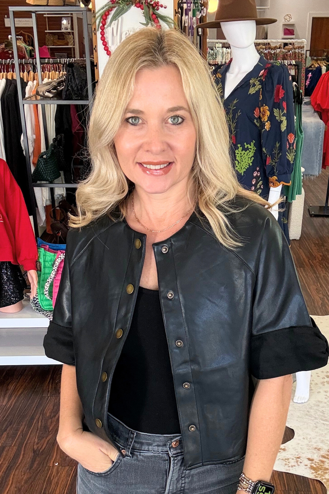 Elevate your wardrobe with this modern short sleeve faux leather jacket. Featuring a sleek button-down front and luxe suede trim detailing along the arms, it strikes the perfect balance between edgy and refined. The soft lining ensures all-day comfort, making it an ideal layering piece for transitional seasons. 