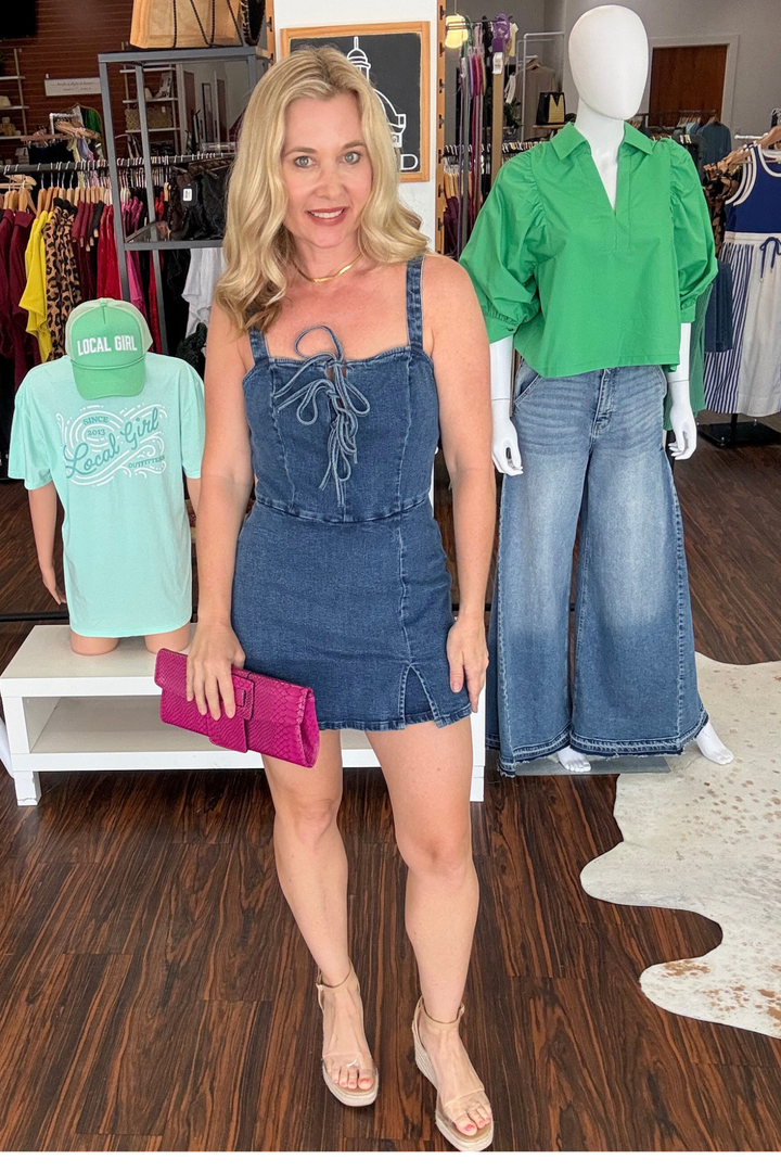 Effortless style meets playful charm in this washed denim skort romper. The straight neckline creates a flattering silhouette, while three decorative bow ties add a whimsical touch. A convenient back zipper closure ensures easy on-and-off wear. Perfect for casual outings, weekend adventures, or laid-back summer days. The soft, washed denim fabric offers comfort and durability, making this piece a versatile addition to any wardrobe. 