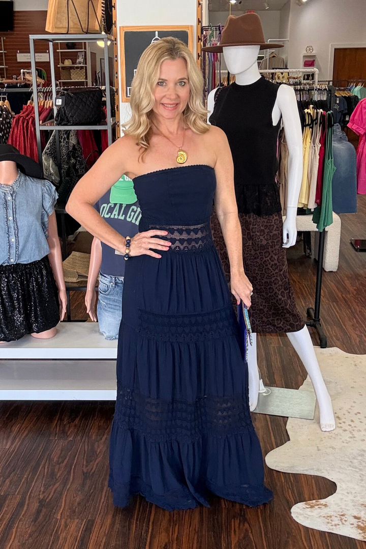 
Embrace effortless elegance in this strapless maxi dress, designed with delicate crochet detailing at the waist that adds texture and visual interest. The flowing triple-tiered skirt creates graceful movement with every step, perfect for warm-weather occasions. The clean strapless neckline offers a timeless silhouette that works beautifully with sandals for a relaxed, polished look. Ideal for beach days, casual events, or sunset gatherings. 