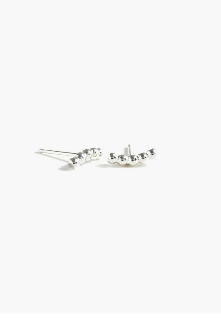 Able Caesar Stud Earrings

These versatile Caesar studs transition seamlessly from everyday wear to statement-making moments. Crafted in 14k gold fill, the 10mm beaded texture adds subtle dimension and visual interest. The innovative design allows you to wear them horizontally or vertically, giving you flexibility to match your mood and style. Perfect for layering or standing alone, these earrings are a modern essential that works as hard as you do.