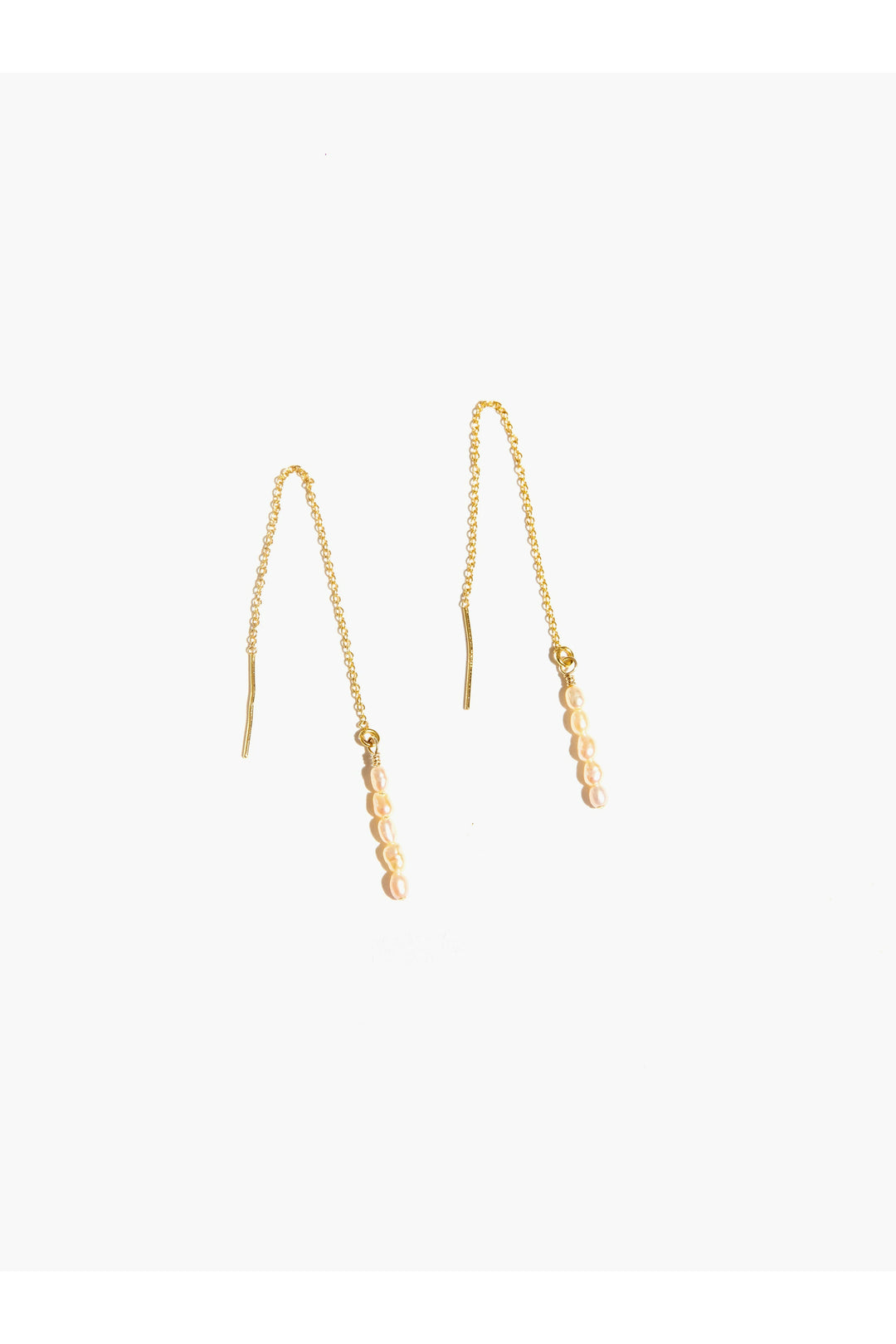 
Elevate your everyday elegance with these limited-edition threader earrings, designed for the discerning eye. Each 4" drop features five delicate blush cultured pearls cascading along a 14k gold fill threader, creating a sophisticated movement that catches light beautifully. The soft pearl tones paired with warm gold create a timeless yet contemporary aesthetic. Perfect for those who appreciate understated luxury and distinctive style.