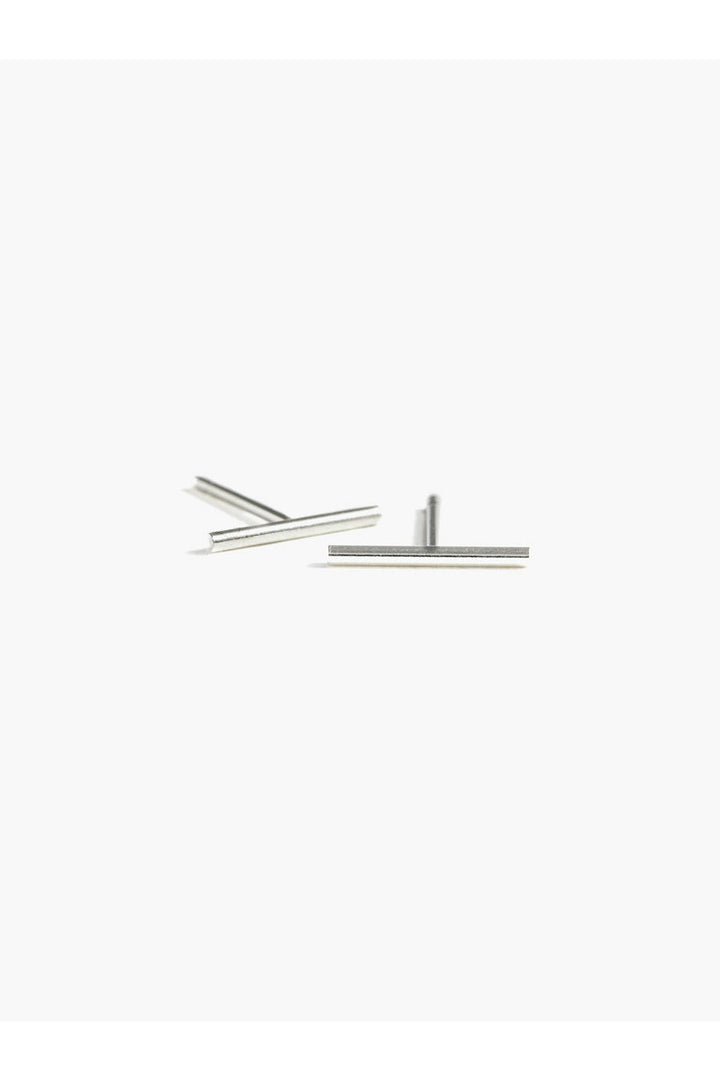 
Sleek and wearable every day, these minimalist studs feature a polished 10mm round bar design. Crafted in your choice of gold-filled or sterling silver, they're the effortless accessory that transitions seamlessly from work to weekend.